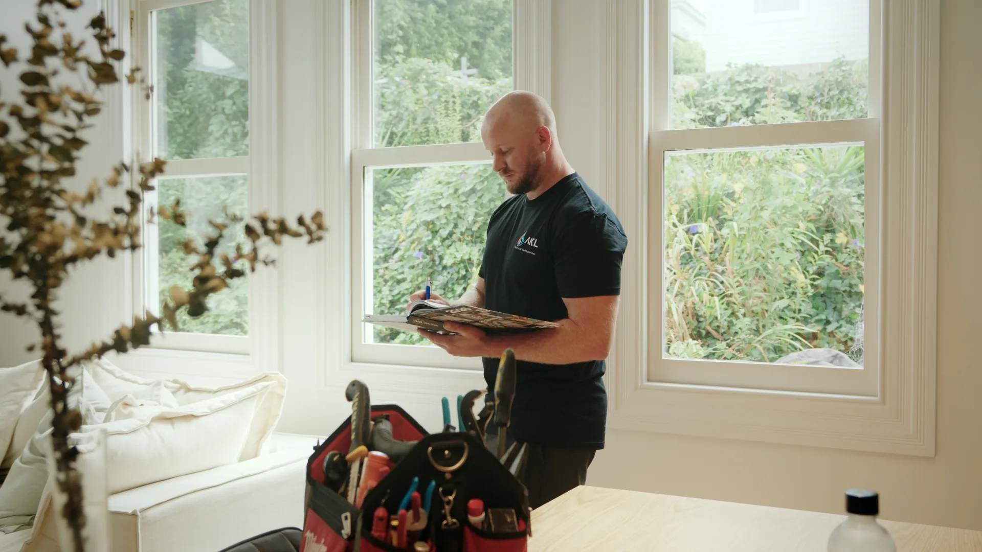 AKL Plumbing reviewing project notes on site